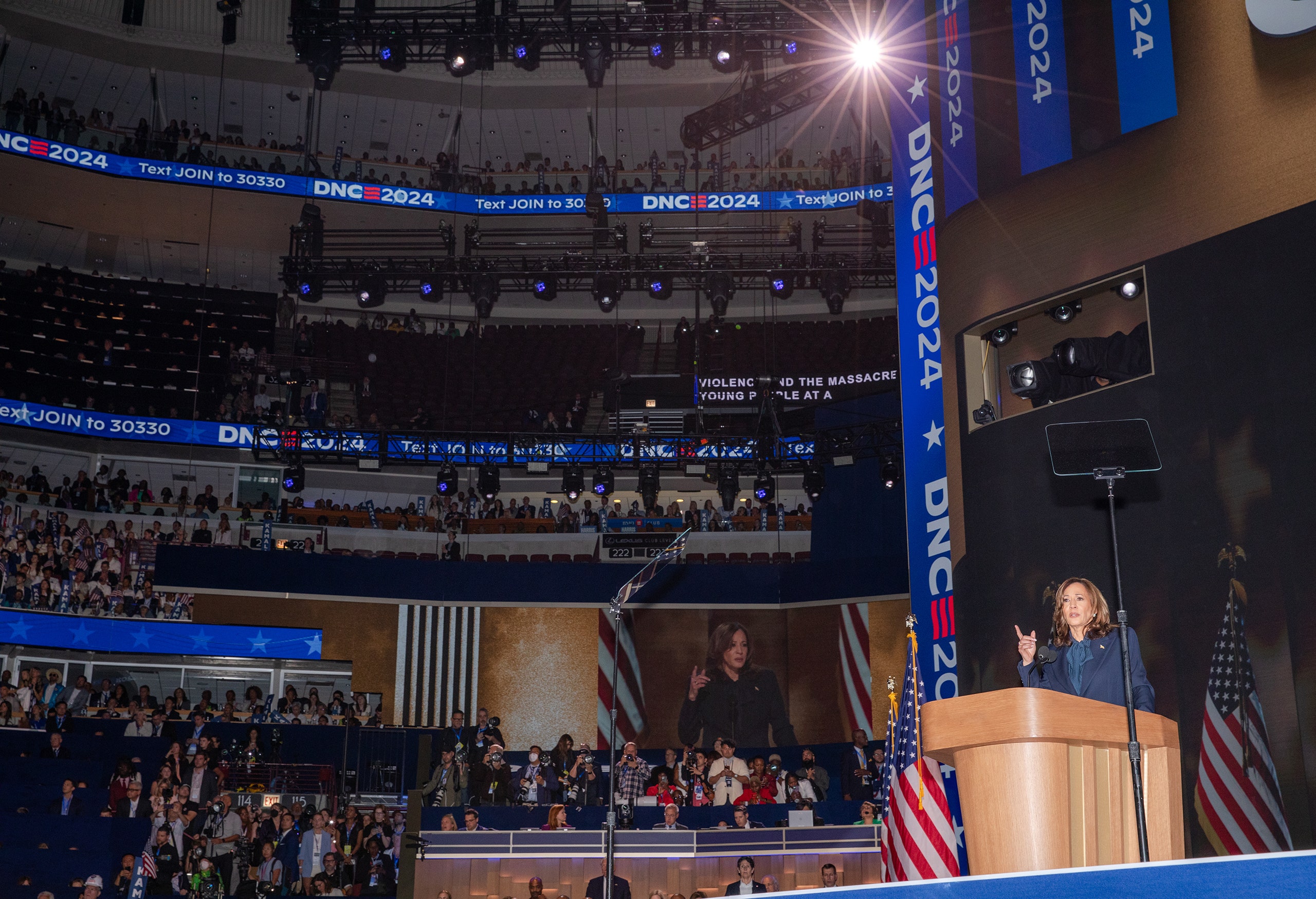 U.S. Vice President Kamala Harris speaking at the 2024 Democratic National Convention. Harris is seen behind a podium...