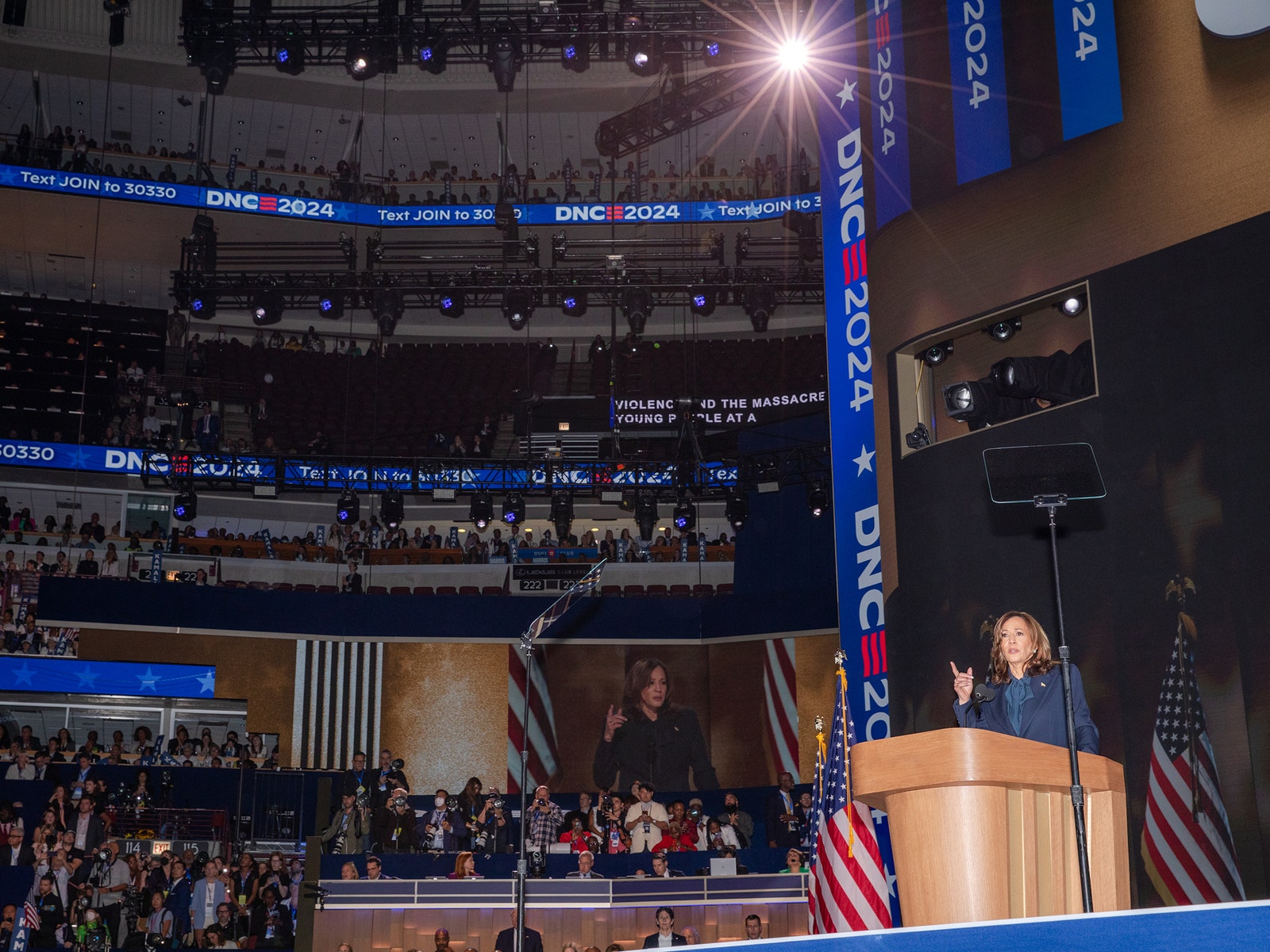 U.S. Vice President Kamala Harris speaking at the 2024 Democratic National Convention. Harris is seen behind a podium...