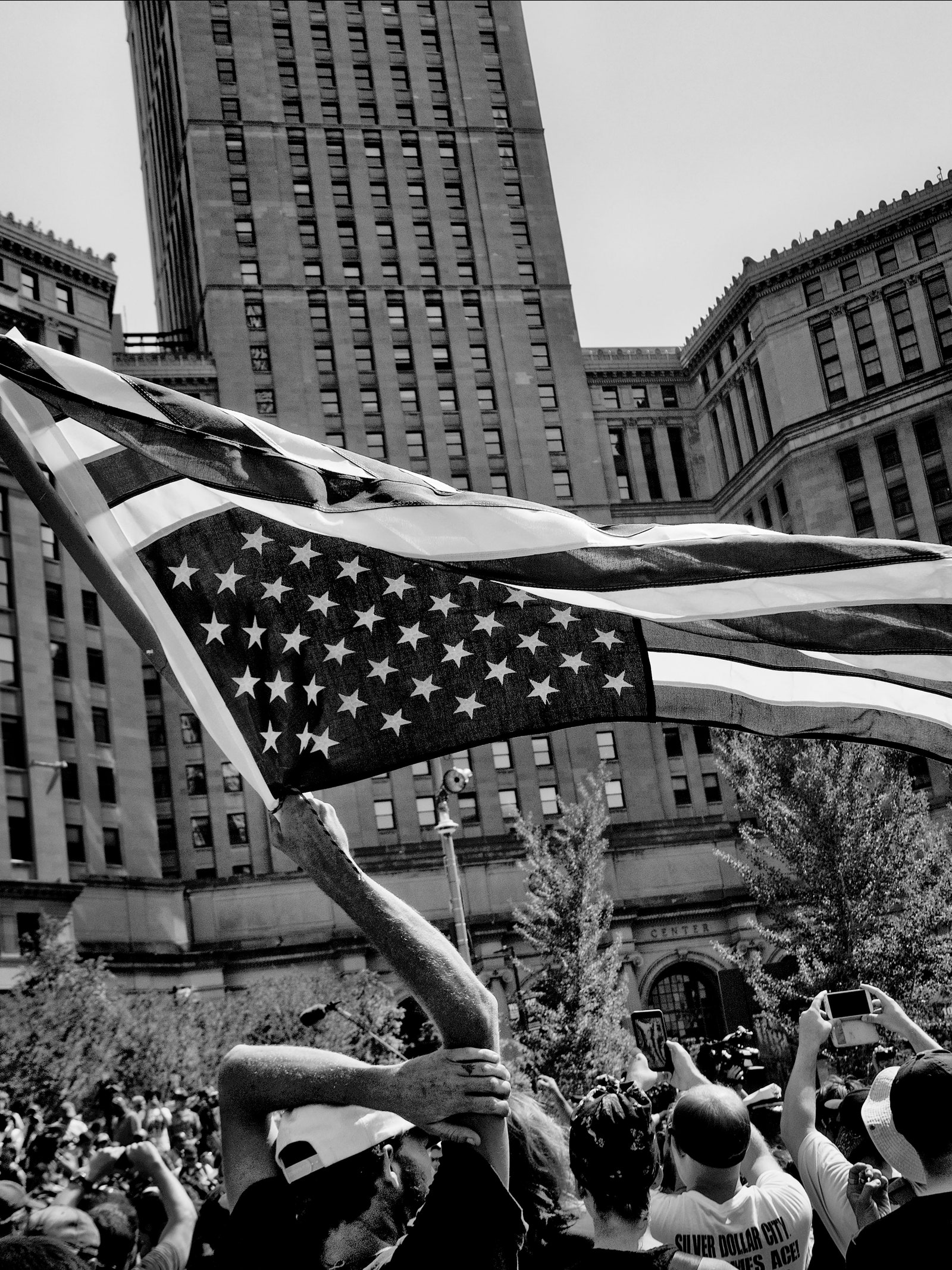 A blackandwhite photo of protesters rallying in Cleveland Ohio during the Republican National Convention in 2016.